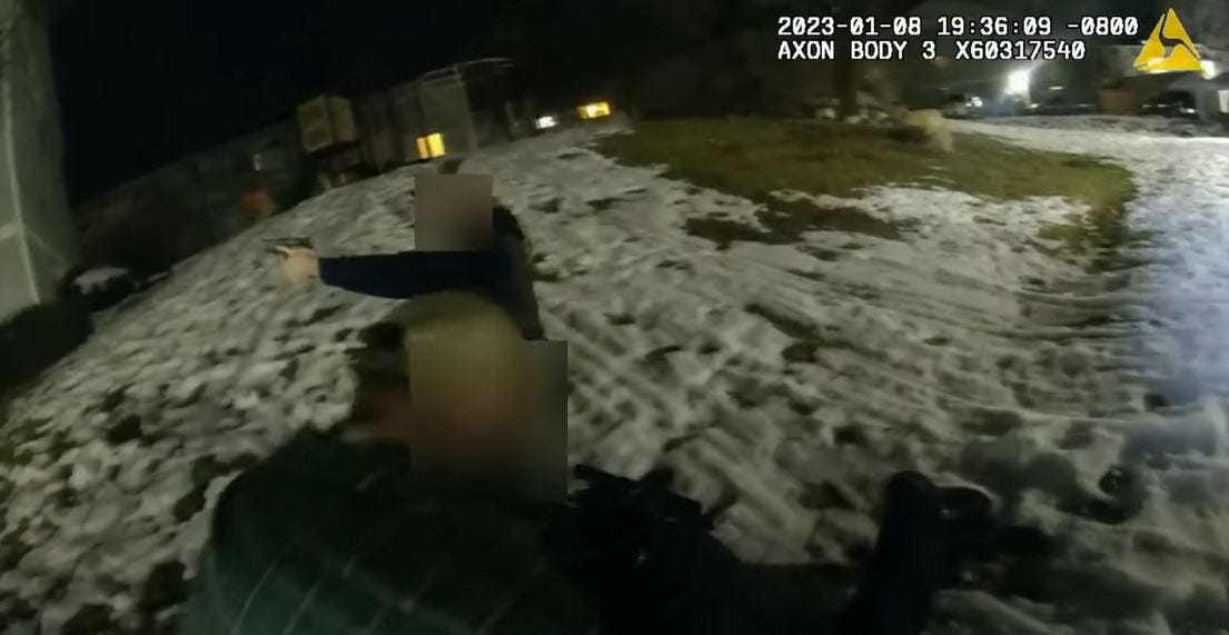 An armed woman provides cover while a man applies a tourniquet to Reno police officer who was wounded during a Jan. 8 shootout at a west Reno apartment complex.  Their faces were blurred.