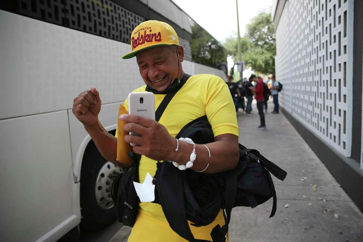 Ernesto Sosa Garcia, 47, of Cuba, celebrates as he is dropped off with other migrants April 22, 2022, at the Greyhound bus station in downtown San Antonio after their release from immigration detention.