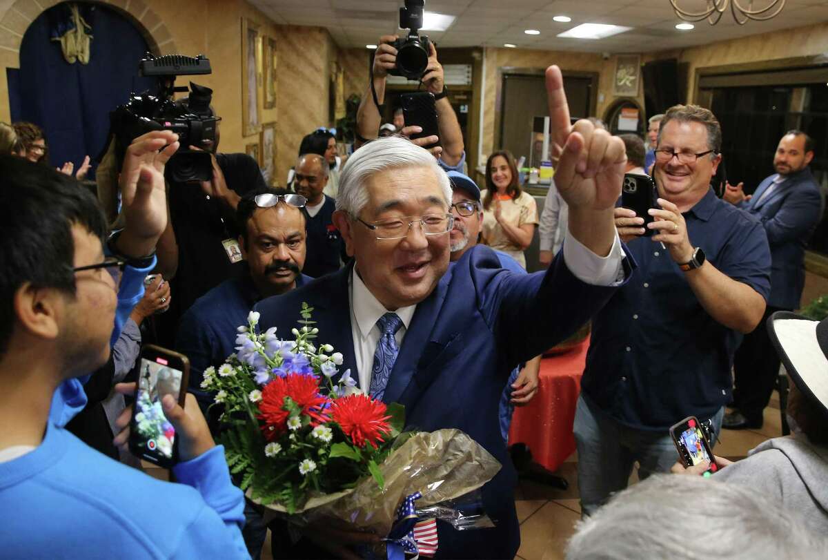Peter Sakai, Democratic candidate for Bexar County judge, gestures to supporters as he arrives at his campaign party Nov. 8, 2022, at House of Nizam.