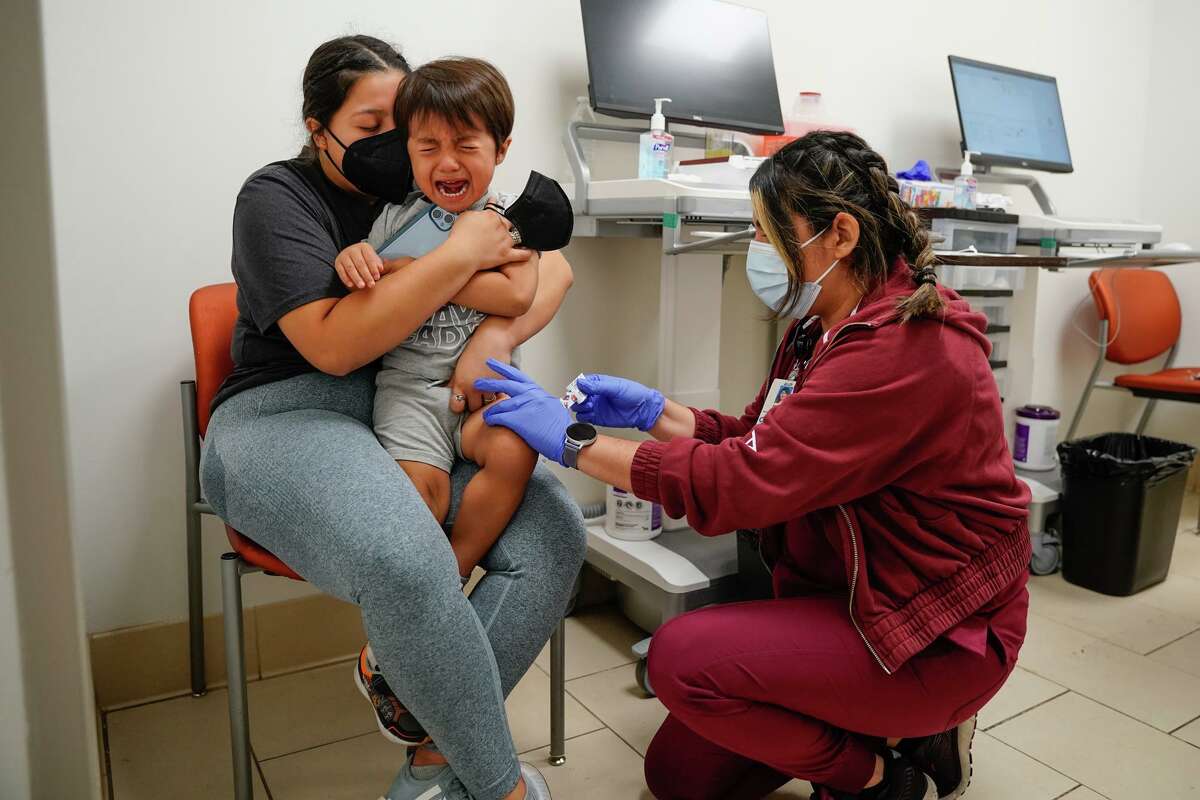 Ezra Von Allnen, 4, reacts to getting a COVID vaccine from University Health’s medical assistant Michelle Robledo during a June 30 vaccination clinic sponsored by University Health at its Robert B. Green campus downtown. Comforting Ezra is his mother, Lauren Von Allnen.