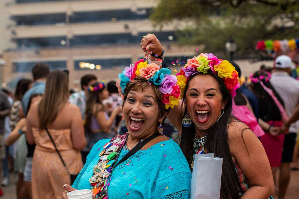 Roxie Chung cracks a cascaron over Sylvia Dimayuga’s head during for first night of Fiesta’s A Night in Old San Antonio on April 5, 2022. In a sign of the return of normalcy, Fiesta returned in full force. A scaled-back version was held in 2021 and the event was canceled in 2020 because of the COVID pandemic.