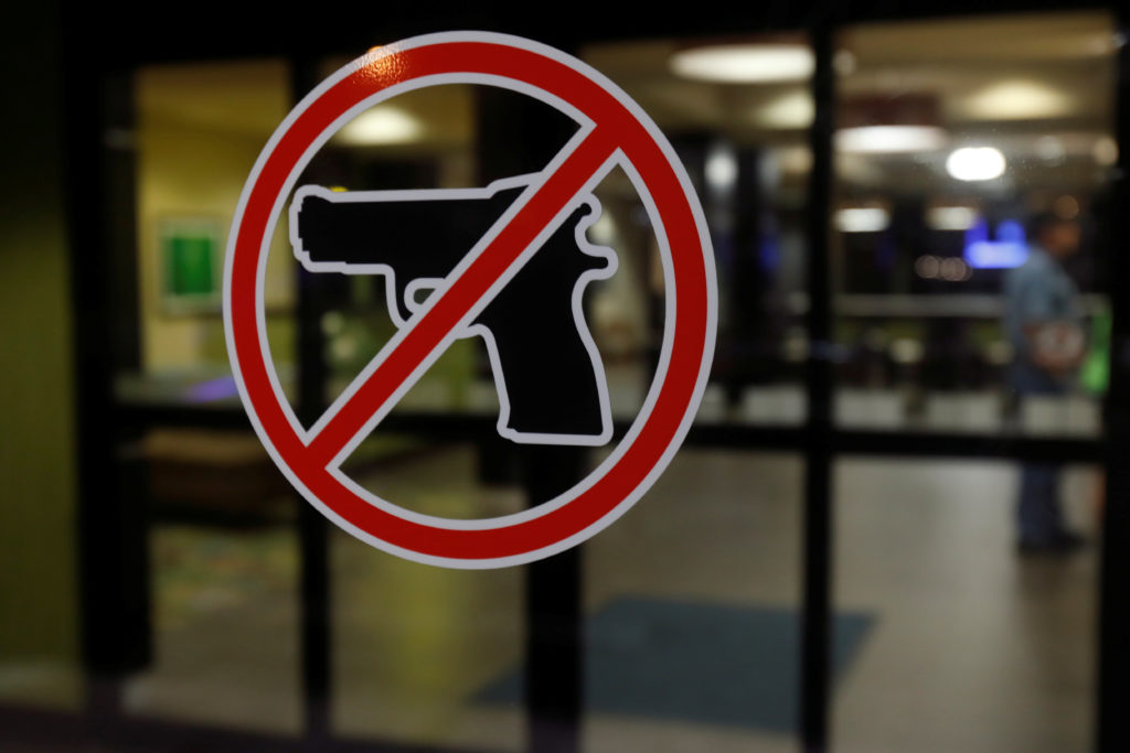 A no gun sign is seen posted outside a hotel in Sikeston, Missouri